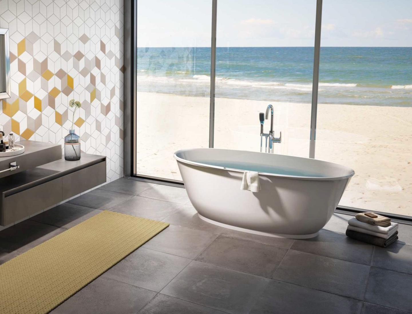 free-standing bath tub by windows looking onto beach